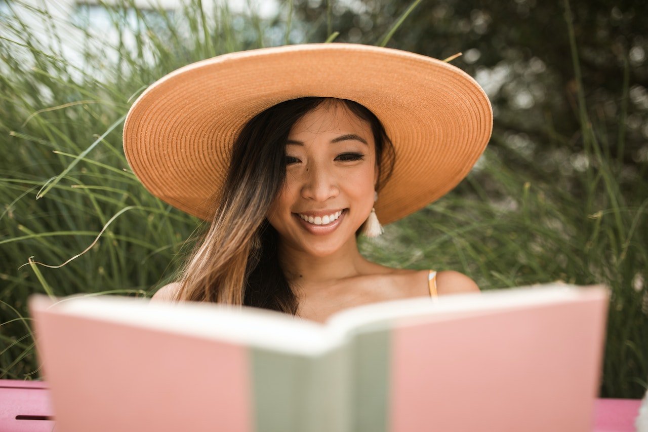 Photo by Mental Health America  (MHA): https://www.pexels.com/photo/smiling-woman-wearing-a-sun-hat-and-reading-a-book-5531323/
